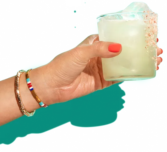 Hand holding a tequila cocktail in a rocks glass