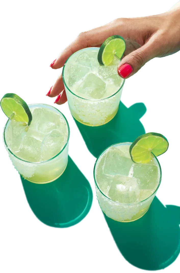 Three glasses of Milagro tequila with lime wedges